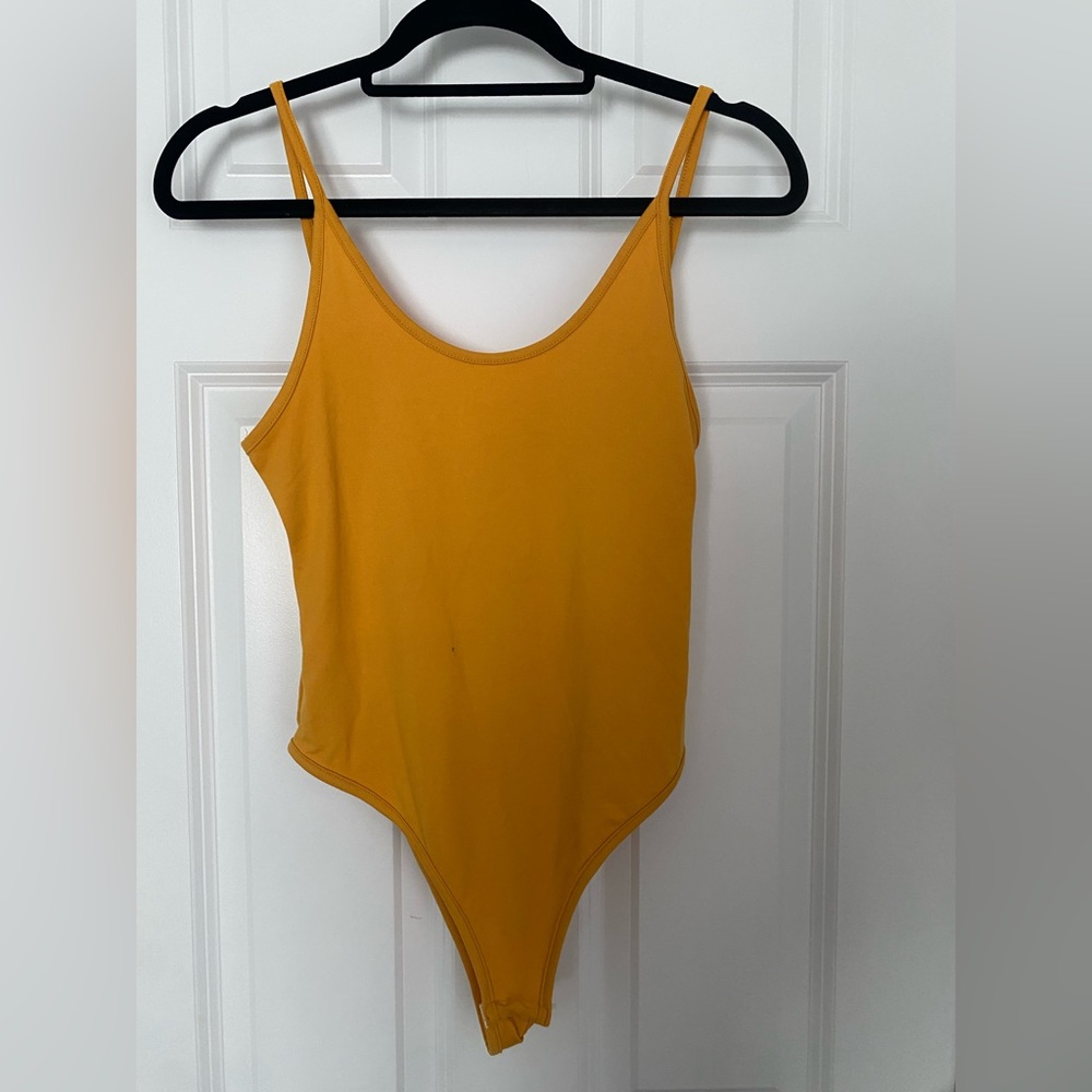 Yellow low cut back bodysuit